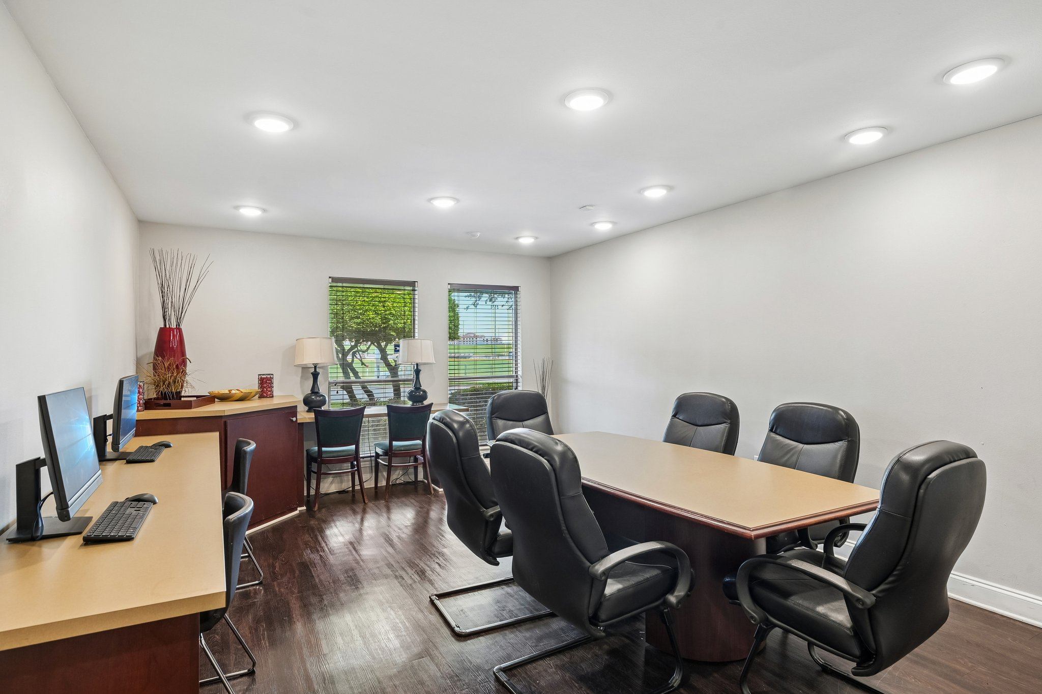 A conference room with a long table and chairs.